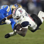 
              Arizona wide receiver Jacob Cowing, right, is tackled by UCLA defensive back Stephan Blaylock during the second half of an NCAA college football game Saturday, Nov. 12, 2022, in Pasadena, Calif. (AP Photo/Mark J. Terrill)
            