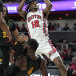 
              Houston guard Tramon Mark (12) draws a block from Norfolk State guard Joe Bryant Jr. (4) during the first half of an NCAA college basketball game, Tuesday, Nov. 29, 2022, in Houston. (AP Photo/Kevin M. Cox)
            