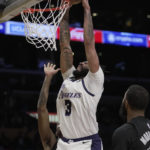 
              Los Angeles Lakers forward Anthony Davis (3) dunks during the first half of an NBA basketball game against the Brooklyn Nets in Los Angeles, Sunday, Nov. 13, 2022. (AP Photo/Ashley Landis)
            