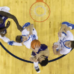 
              Creighton's Baylor Scheierman, second from left, snags a rebound over Holy Cross' Caleb Kenney, second from right, as Holy Cross' Gerrale Gates, left, and Creighton's Ryan Kalkbrenner, right, stand by during the first half of an NCAA college basketball game on Monday, Nov. 14, 2022, in Omaha, Neb. (AP Photo/Rebecca S. Gratz)
            
