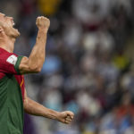 
              Portugal's Cristiano Ronaldo celebrates after scoring his side's opening goal during the World Cup group H soccer match between Portugal and Uruguay, at the Lusail Stadium in Lusail, Qatar, Monday, Nov. 28, 2022. (AP Photo/Abbie Parr)
            