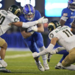 
              Air Force running back Brad Roberts, center, is stopped after a short gain by Colorado State linebacker Chase Wilson, left, and defensive back Henry Blackburn in the first half of an NCAA college football game Saturday, Nov. 19, 2022, at Air Force Academy, Colo. (AP Photo/David Zalubowski)
            
