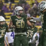 
              UAB linebacker Noah Wilder (50) celebrates a recovery of an LSU fumble during the first half of an NCAA college football game in Baton Rouge, La., Saturday, Nov. 19, 2022. (AP Photo/Matthew Hinton)
            