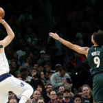 
              Dallas Mavericks guard Luka Doncic (77) shoots as Boston Celtics guard Derrick White (9) tries to defend during the first half of an NBA basketball game, Wednesday, Nov. 23, 2022, in Boston. (AP Photo/Mary Schwalm)
            
