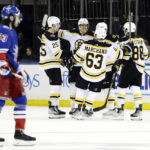 
              Boston Bruins defenseman Hampus Lindholm (27) is congratulated by teammates after scoring an empty-net goal as New York Rangers center Mika Zibanejad (93) skates to the bench in the third period of an NHL hockey game Thursday, Nov. 3, 2022, in New York. (AP Photo/Adam Hunger)
            