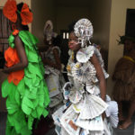 
              Jalokun Nifemi, wearing an outfit made from recycled newspapers, waits back stage before a 'trashion show' in Sangotedo Lagos, Nigeria, Saturday, Nov. 19, 2022. (AP Photo/Sunday Alamba)
            