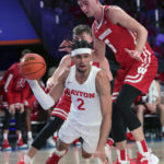 
              This photo provided by Bahamas Visual Services shows Dayton forward Toumani Camara being defended by Wisconsin forward Tyler Wahl (5) during an NCAA college basketball game at the Battle 4 Atlantis at Paradise Island, Bahamas, Wednesday, Nov. 23, 2022. . (Tim Aylen/Bahamas Visual Services via AP)
            
