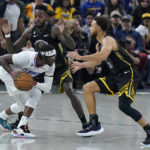 
              Los Angeles Clippers guard Reggie Jackson, front left, is defended by Golden State Warriors forward JaMychal Green, back left, and guard Stephen Curry during the first half of an NBA basketball game in San Francisco, Wednesday, Nov. 23, 2022. (AP Photo/Jeff Chiu)
            