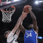 
              Kentucky forward Oscar Tshiebwe (34) is fouled by Michigan State center Carson Cooper (15) as he drives to the basket during the first half on an NCAA college basketball game, Tuesday, Nov. 15, 2022, in Indianapolis. (AP Photo/Darron Cummings)
            