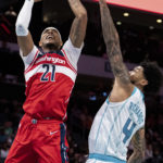 
              Washington Wizards center Daniel Gafford (21) drives to the basket while guarded by Charlotte Hornets center Nick Richards (4) in the second half of an NBA preseason basketball game in Charlotte, N.C., Monday, Oct. 10, 2022. (AP Photo/Jacob Kupferman)
            