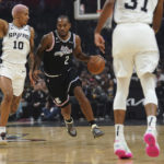 
              Los Angeles Clippers forward Kawhi Leonard (2) drives as San Antonio Spurs' Jeremy Sochan (10) defends during the first half of an NBA basketball game Saturday, Nov. 19, 2022, in Los Angeles. (AP Photo/Allison Dinner)
            
