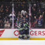 
              Vancouver Canucks' Brock Boeser, right, Nils Hoglander (21) and Tyler Myers celebrate Boeser's second goal against the Los Angeles Kings, during the third period of an NHL hockey game Friday, Nov. 18, 2022, in Vancouver, British Columbia. (Darryl Dyck/The Canadian Press via AP)
            