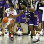 
              Lamar guard Cody Pennebaker (0) tips the ball away from TCU guard Mike Miles Jr. (1) in the second half during an NCAA college basketball game Friday, Nov. 11 2022, in Fort Worth, Texas. (AP Photo/Richard W. Rodriguez)
            