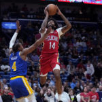 
              New Orleans Pelicans forward Brandon Ingram (14) goes to the basket against Golden State Warriors guard Moses Moody (4) in the first half of an NBA basketball game in New Orleans, Friday, Nov. 4, 2022. (AP Photo/Gerald Herbert)
            
