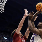 
              Kansas forward K.J. Adams Jr., right, shoots over Southern Utah forward Maizen Fausett during the first half of an NCAA college basketball game Friday, Nov. 18, 2022, in Lawrence, Kan. (AP Photo/Charlie Riedel)
            