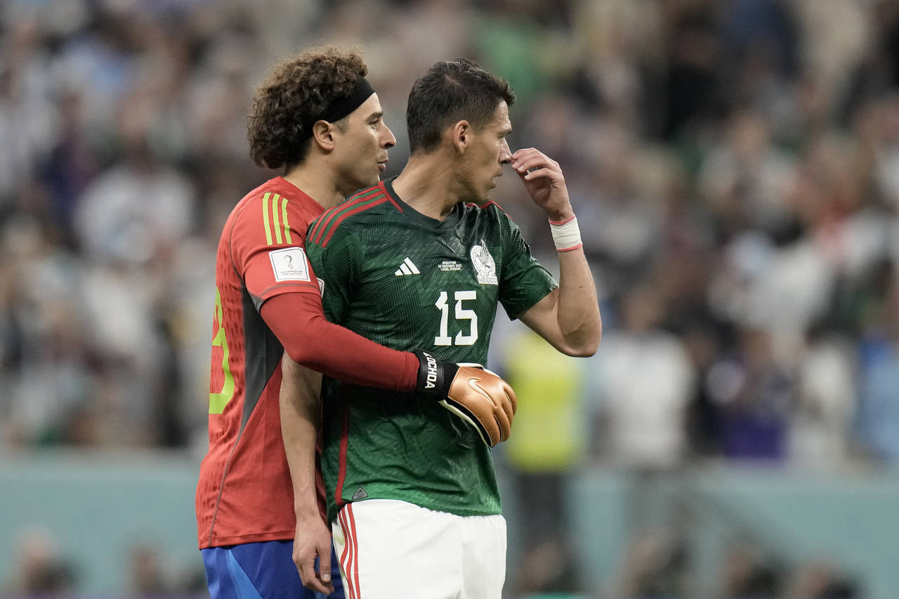 Mexico's goalkeeper Guillermo Ochoa embraces teammate Hector Moreno, right, at the end of the World...