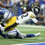 
              Pittsburgh Steelers' Najee Harris (22) dives in for a touchdown against Indianapolis Colts' Julian Blackmon (32) and Kenny Moore II (23) during the first half of an NFL football game, Monday, Nov. 28, 2022, in Indianapolis. (AP Photo/Michael Conroy)
            