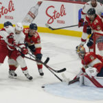 
              Florida Panthers goaltender Spencer Knight (30) defends the net from a shot by Carolina Hurricanes center Jack Drury (18) during the first period of an NHL hockey game, Wednesday, Nov. 9, 2022, in Sunrise, Fla. (AP Photo/Marta Lavandier)
            