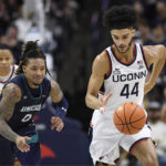 
              Connecticut's Andre Jackson Jr. (44) steals the ball from UNC Wilmington guard Jamarii Thomas (0) in the second half of an NCAA college basketball game, Friday, Nov. 18, 2022, in Storrs, Conn. (AP Photo/Jessica Hill)
            