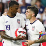 
              FILE - U.S. forward Christian Pulisic, right, hands the ball to Haji Wright (19) prior to a penalty kick during the second half of the team' international friendly soccer match against Morocco on Wednesday, June 1, 2022, in Cincinnati. Tim Ream, Haji Wright, Joe Scally and Sean Johnson made the United States’ World Cup roster.  (AP Photo/Jeff Dean, FIle)
            