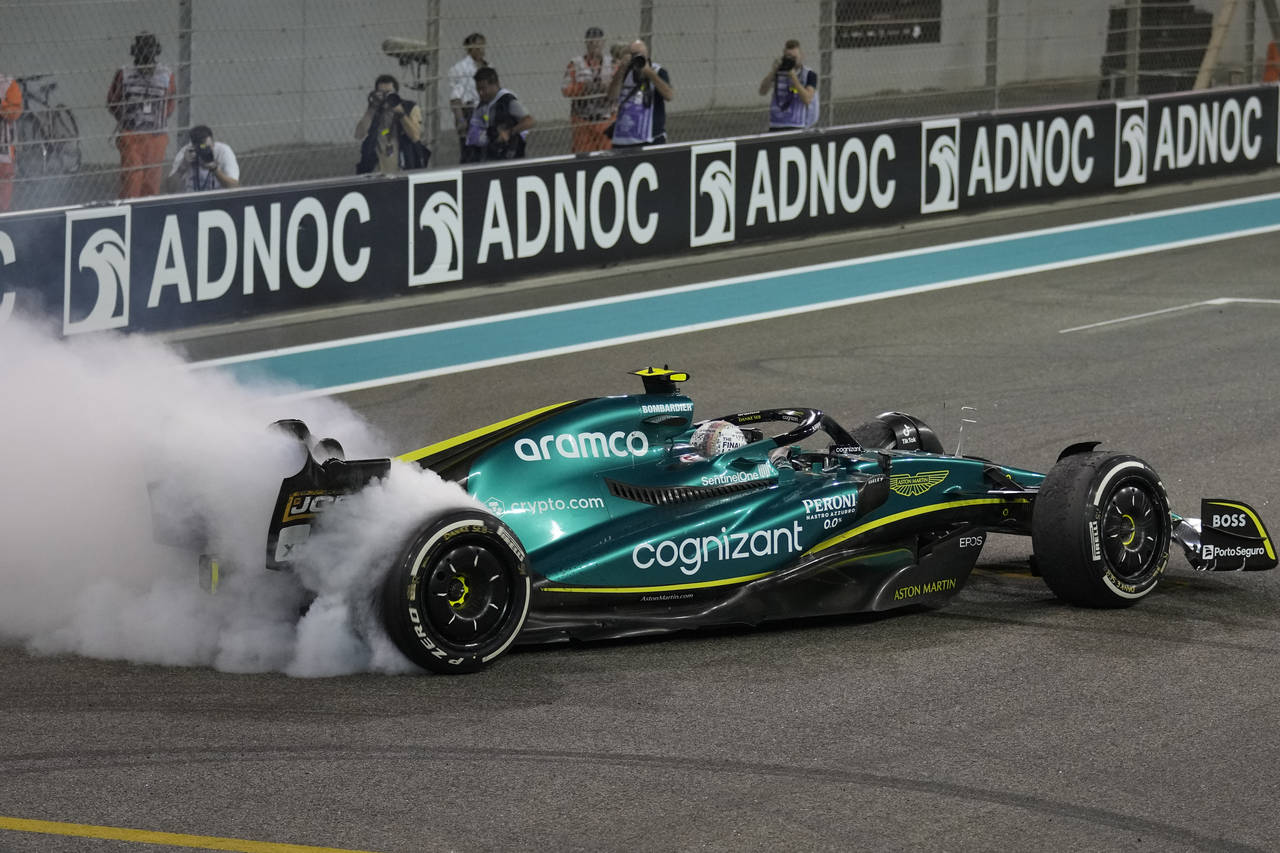 Aston Martin driver Sebastian Vettel of Germany burns the tires as he finished his last race in car...