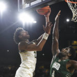 
              Michigan guard Kobe Bufkin, left, drives to the basket against Ohio forward Dwight Wilson III in overtime of an NCAA college basketball game, Sunday, Nov. 20, 2022, in Ann Arbor, Mich. (AP Photo/Jose Juarez)
            
