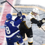 
              Boston Bruins center Trent Frederic (11) and Tampa Bay Lightning defenseman Ian Cole (28) collide during the first period of an NHL hockey game Tuesday, Nov. 29, 2022, in Boston. (AP Photo/Charles Krupa)
            