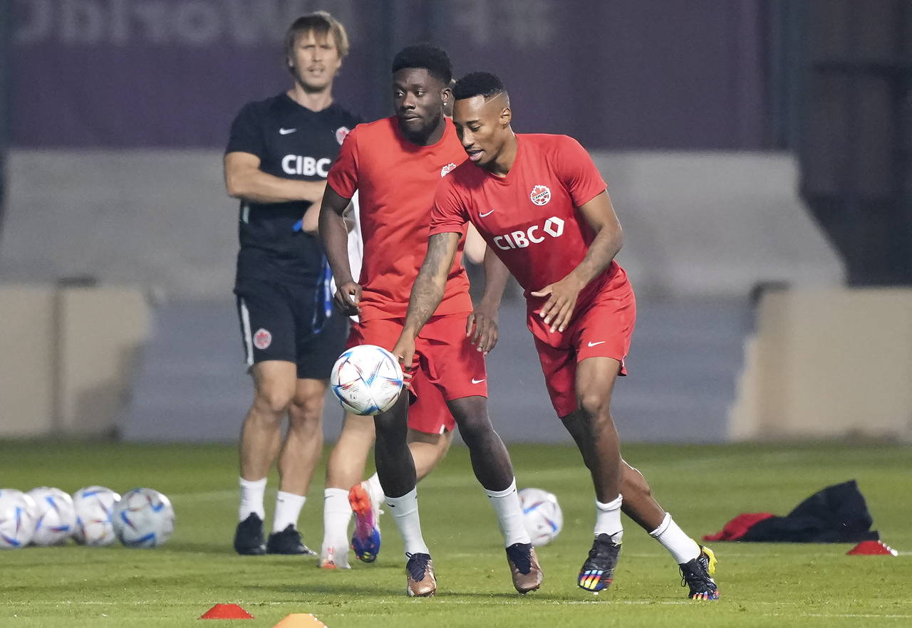 Canada midfielder Mark-Anthony Kaye, right, take part in a drill with teammate forward Alphonso Dav...
