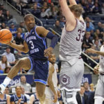 
              BYU guard Rudi Williams (3) passes the ball as Missouri State forward Dawson Carper (33) defends during the second half of an NCAA college basketball game Wednesday, Nov. 16, 2022, in Provo, Utah. (AP Photo/Rick Bowmer)
            
