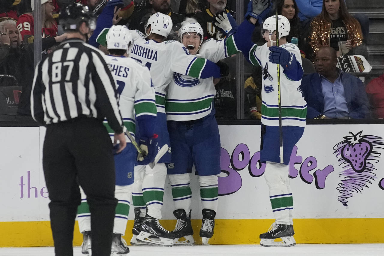 Vancouver Canucks left wing Andrei Kuzmenko, second from right, celebrates after scoring against th...