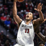 
              San Diego State forward Jaedon LeDee (13) shoots during the second half of the team's NCAA college basketball game against BYU on Friday, Nov. 11, 2022, in San Diego. (AP Photo/Denis Poroy)
            
