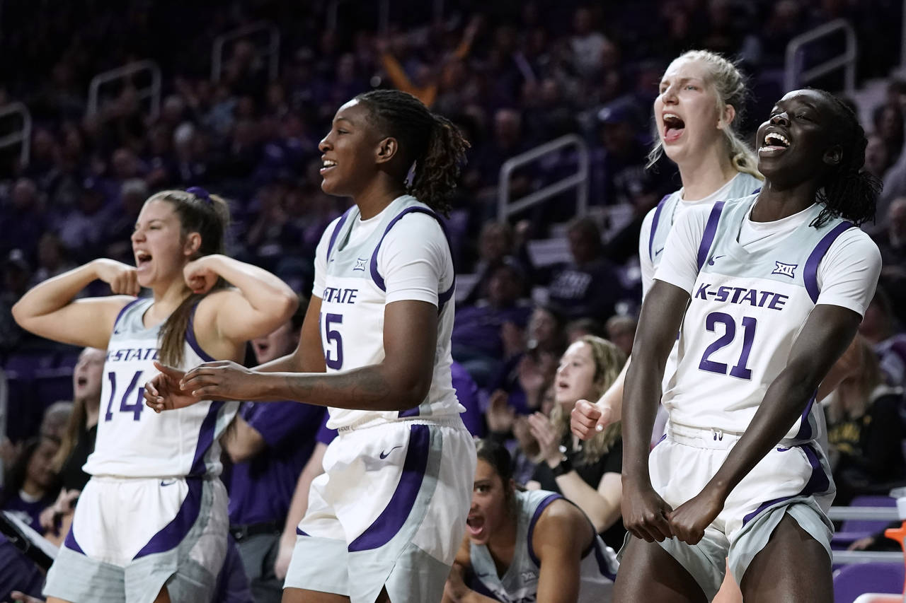 Kansas State players celebrate after a basket during the second half of an NCAA college basketball ...
