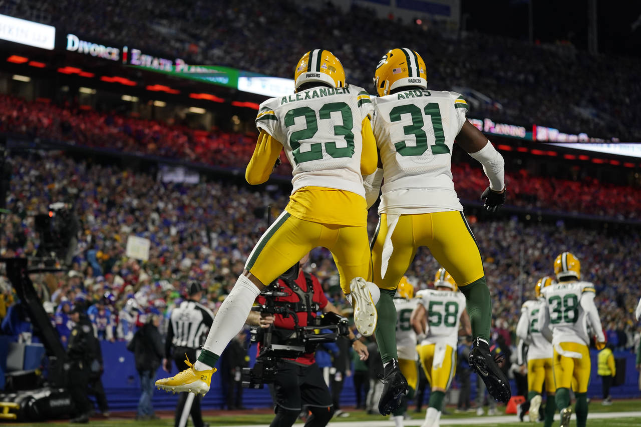 Green Bay Packers cornerback Jaire Alexander (23) celebrates with safety Adrian Amos (31) after int...