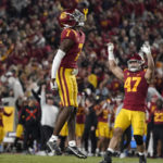 
              Southern California defensive back Calen Bullock (7) celebrates along with defensive lineman Stanley Ta'ufo'ou, right, after intercepting a pass during the second half of an NCAA college football game against Notre Dame Saturday, Nov. 26, 2022, in Los Angeles. (AP Photo/Mark J. Terrill)
            