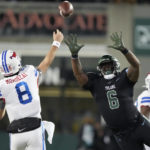 
              Southern Methodist quarterback Tanner Mordecai (8) passes under pressure from Tulane linebacker Darius Hodges (6) during the first half of an NCAA college football game in New Orleans, Thursday, Nov. 17, 2022. (AP Photo/Gerald Herbert)
            