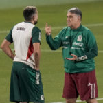 
              Mexico's head coach Gerardo Martino, right talks with Hector Herrera during a training session in Jor, Qatar, Wednesday, Nov. 23, 2022. (AP Photo/Moises Castillo)
            
