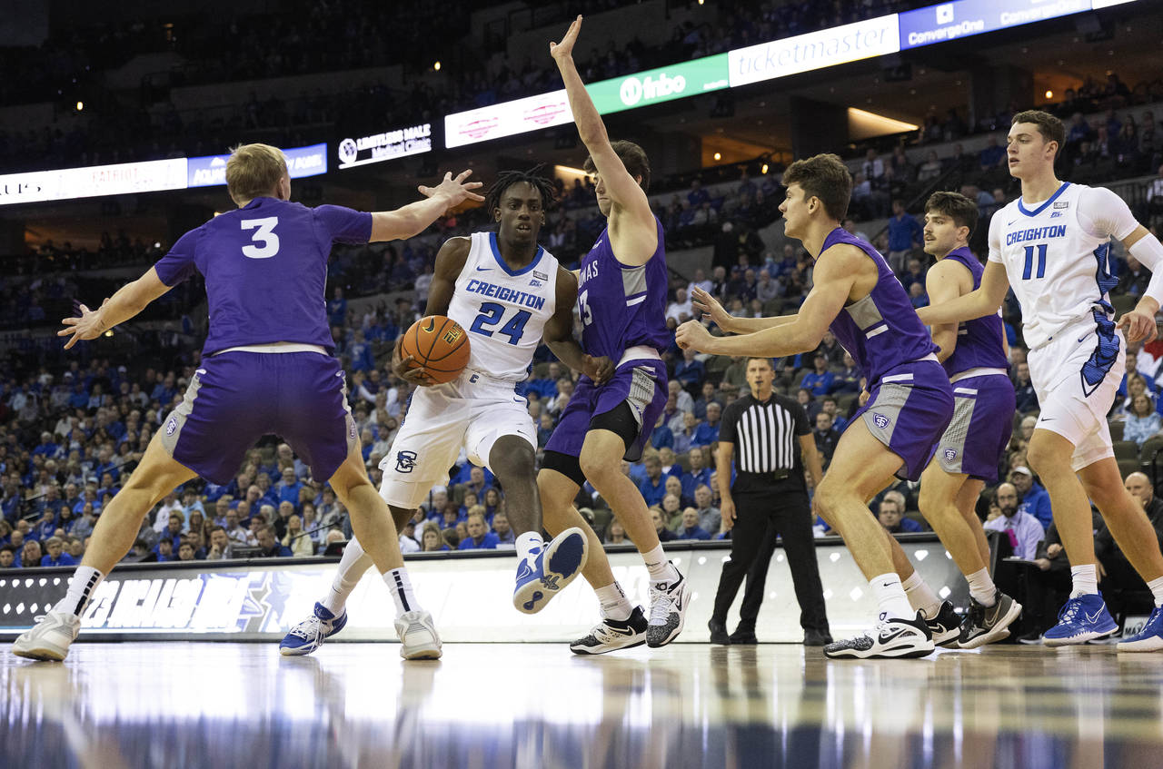 Creighton's Arthur Kaluma, second from left, drives for the basket against St. Thomas' Andrew Rohde...