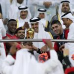 
              FILE - Al Duhail players receive the trophy from the Emir of Qatar Sheikh Tamim bin Hamad Al Thani, center, after they beat Al Sadd in Amir cup final match in Doha, Qatar, Thursday, May 16, 2019. Qatar will host the 2022 FIFA World Cup but soccer isn't the only sport played in the Gulf Arab country. From traditional pursuits to worldwide competitions, Qatar increasingly has marketed itself as a host for sports of all sorts. (AP Photo/Kamran Jebreili, File)
            