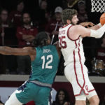 
              Oklahoma forward Tanner Groves (35) grabs a rebound in front of UNC Wilmington center Victor Enoh (12) in the second half of an NCAA college basketball game Tuesday, Nov. 15, 2022, in Norman, Okla. (AP Photo/Sue Ogrocki)
            