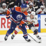 
              Florida Panthers' Matthew Tkachuk (19) chases Edmonton Oilers' Darnell Nurse (25) during the third period of an NHL hockey game in Edmonton, Alberta, Monday, Nov. 28, 2022. (Jason Franson/The Canadian Press via AP)
            