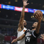 
              Los Angeles Clippers forward Norman Powell, right, shoots as Denver Nuggets forward Bruce Brown defends during the first half of an NBA basketball game Friday, Nov. 25, 2022, in Los Angeles. (AP Photo/Mark J. Terrill)
            