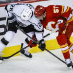 
              Los Angeles Kings forward Jaret Anderson-Dolan, left, and Calgary Flames defenceman Nick DeSimone battle for the puck during the second period of an NHL hockey game in Calgary, Alberta, Monday, Nov. 14, 2022. (Jeff McIntosh/The Canadian Press via AP)
            