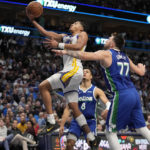 
              Golden State Warriors forward Patrick Baldwin Jr. leaps to the basket for a shot after getting past Dallas Mavericks guard Luka Doncic (77) in the second half of an NBA basketball game in Dallas, Tuesday, Nov. 29, 2022. (AP Photo/Tony Gutierrez)
            