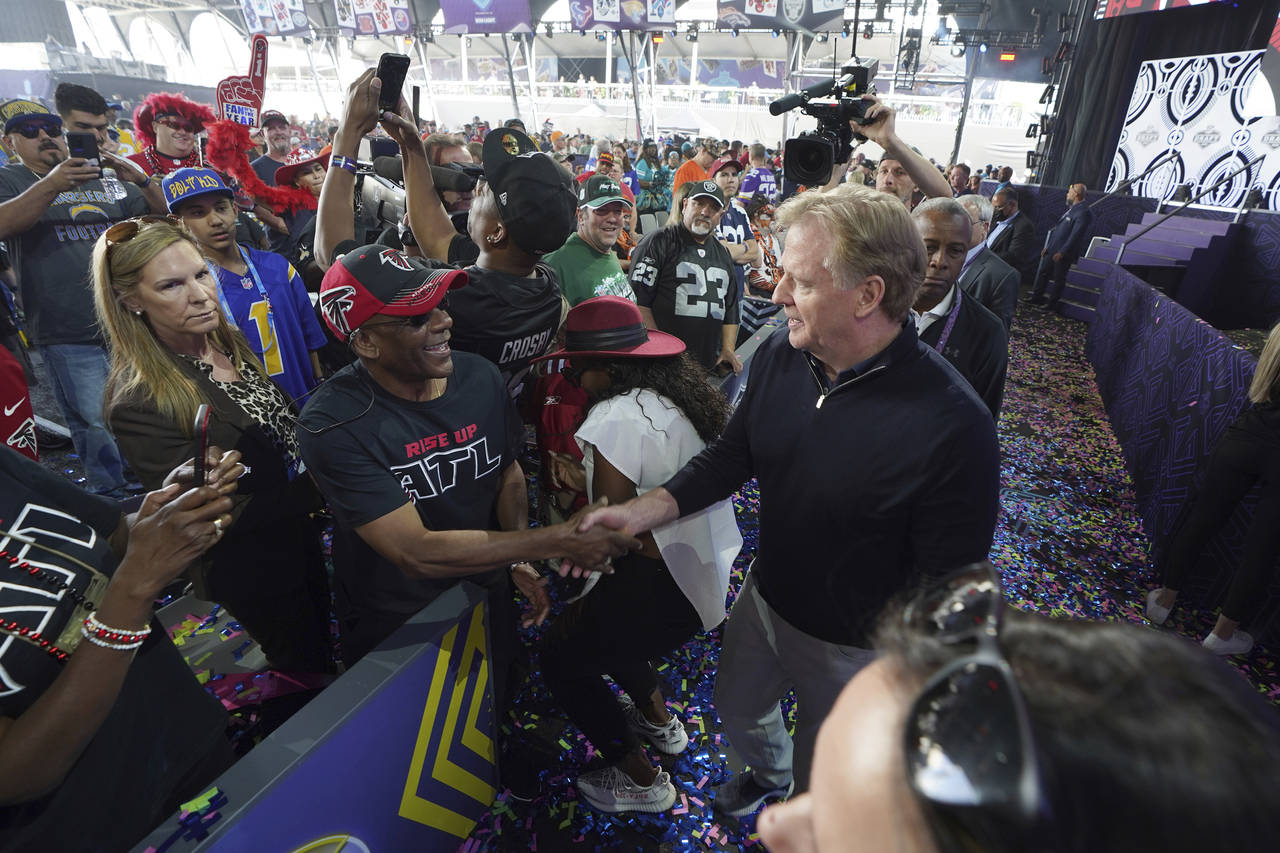 FILE - NFL Commissioner Roger Goodell interacts with fans during the 2022 NFL Draft in Las Vegas, S...