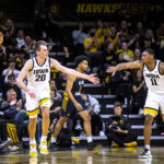 
              Iowa forward Payton Sandfort, left, gets a high-five from guard Tony Perkins after making a 3-point basket against North Carolina A&T during an NCAA college basketball game Friday, Nov. 11, 2022, in Iowa City, Iowa. (Joseph Cress/Iowa City Press-Citizen via AP)
            