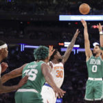 
              Boston Celtics forward Jayson Tatum (0) shoots as New York Knicks forward Julius Randle (30) defends and Boston Celtics guard Marcus Smart (36) watches during the first half of an NBA basketball game Saturday, Nov. 5, 2022, at Madison Square Garden in New York. (AP Photo/Jessie Alcheh)
            