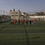 
              Palestinian girls warm-up during a soccer training session at the Beit Hanoun Al-Ahli Youth Club's ground in the northern Gaza strip, Tuesday, Oct. 29, 2022. Women's soccer has been long been neglected in the Middle East, a region that is mad for the men's game and hosts the World Cup for the first time this month in Qatar. (AP Photo/Fatima Shbair)
            