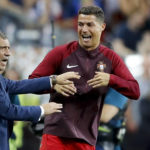 
              FILE - Portugal's Cristiano Ronaldo and Portugal coach Fernando Santos react moments before the end of the Euro 2016 final soccer match between Portugal and France at the Stade de France in Saint-Denis, north of Paris, on July 10, 2016. The last 32-team World Cup will be the shortest  in this era. There are just 28 days from starting on Nov. 21 in Qatar to finishing on Dec. 18. And only 25 days to play seven games if a team from Groups G or H – like Brazil or Portugal – is to reach the final after opening on Nov. 24. (AP Photo/Frank Augstein, File)
            