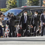 
              Investigators enter the headquarters of major advertising company Dentsu in Tokyo Friday, Nov. 25, 2022. Japanese prosecutors raided the headquarters of Dentsu Friday, as the investigation into corruption related to the Tokyo Olympics widened. (Kyodo News via AP)
            