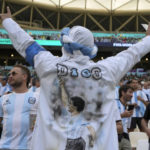 
              A fan wears a shirt of soccer legend Diego Maradona cheers prior to the World Cup group C soccer match between Argentina and Saudi Arabia at the Lusail Stadium in Lusail, Qatar, Tuesday, Nov. 22, 2022. (AP Photo/Ricardo Mazalan)
            